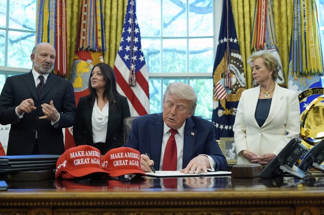 President Donald Trump holds an executive order relating to education in the Oval Office of the White House, Wednesday, April 23, 2025, in Washington, as Commerce Secretary Howard Lutnick, Labor Secretary Lori Chavez-DeRemer and Education Secretary Linda McMahon watch. (AP Photo/Alex Brandon)