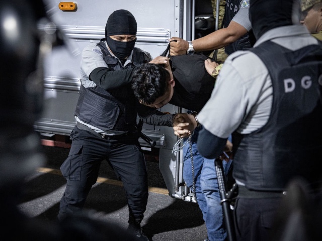 TECOLUCA, EL SALVADOR - MARCH 16: In this handout photo provided by the Salvadoran government, guards escort a newly admitted inmate allegedly linked to criminal organizations at CECOT on March 16, 2025 in Tecoluca, El Salvador. Trump's administration deported 238 alleged members of the Venezuelan criminal organizations 'Tren De Aragua' and Mara Salvatrucha with only 23 being members of the Mara. Nayib Bukele president of El Salvador announced that his government will receive the alleged members of the gang to be taken to CECOT. On February of 2023 El Salvador inaugurated Latin America's largest prison as part of President Nayib Bukele's plan to fight gangs. (Photo by Salvadoran Government via Getty Images)
