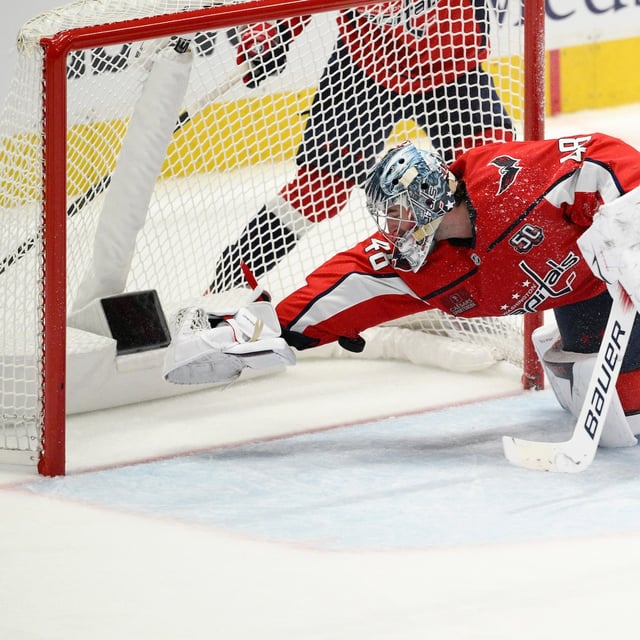 Washington Capitals goaltender Logan Thompson dives for the puck in the third period of Game 2 of a first-round NHL hockey playoff series against the Montreal Canadiens Wednesday, April 23, 2025, in Washington. (AP Photo/Nick Wass)