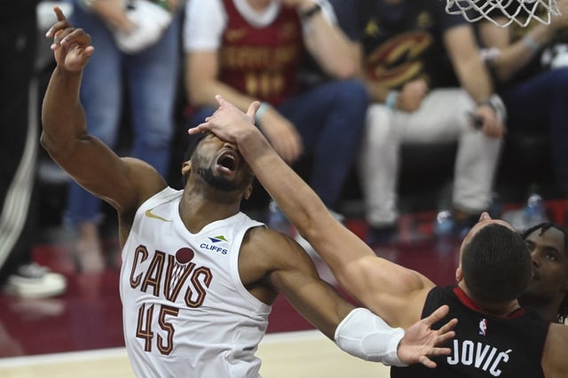 Apr 23, 2025; Cleveland, Ohio, USA; Miami Heat forward Nikola Jovic (5) defends a shot by Cleveland Cavaliers guard Donovan Mitchell (45) in the fourth quarter of game two of the first round of the 2025 NBA Playoffs at Rocket Arena. Mandatory Credit: David Richard-Imagn Images