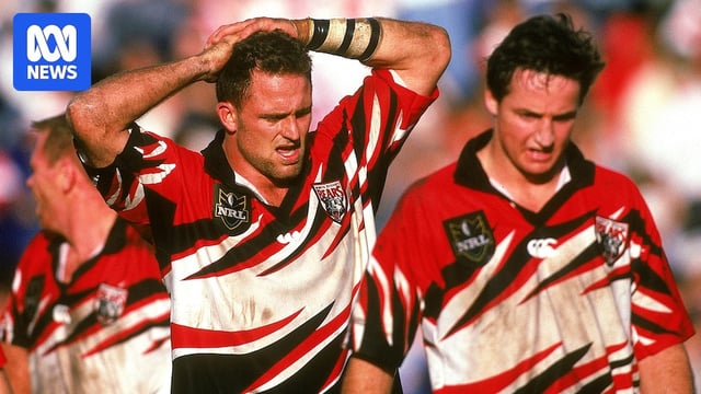 Two NRL players looking tired, walking to their marks, taking deep breaths