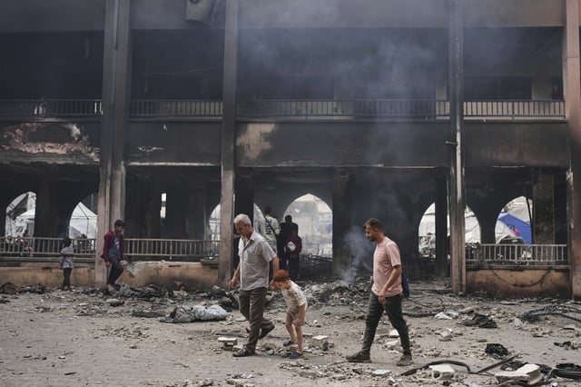 Palestinians inspect the damage after an Israeli army airstrike on Yaffa School, in Gaza City, Wednesday, April 23, 2025. (AP Photo/Jehad Alshrafi)