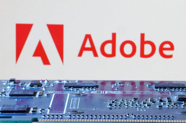 Adobe logo is seen near computer motherboard in this illustration taken January 8, 2024. REUTERS/Dado Ruvic/Illustration/File Photo