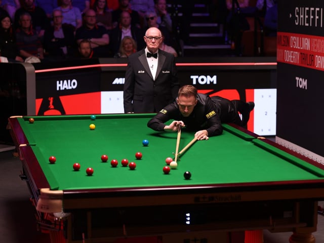Judd Trump of England plays a shot during the first round match of the 2025 World Snooker Championship.