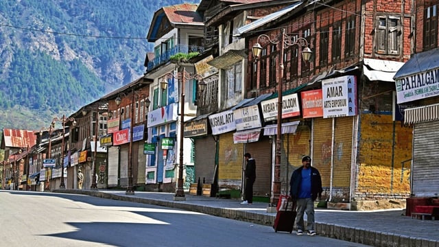 An Indian tourist departs after an attack in Pahalgam, about 90kms (55 miles) from Srinagar on April 23, 2025