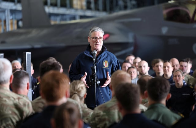British Prime Minister Keir Starmer addresses the crew of the British aircraft carrier HMS Prince Of Wales in front of an F35 fighter aircraft in the hangar of the carrier, which is on an eight month operational deployment. RICHARD POHLE/Pool via REUTERS