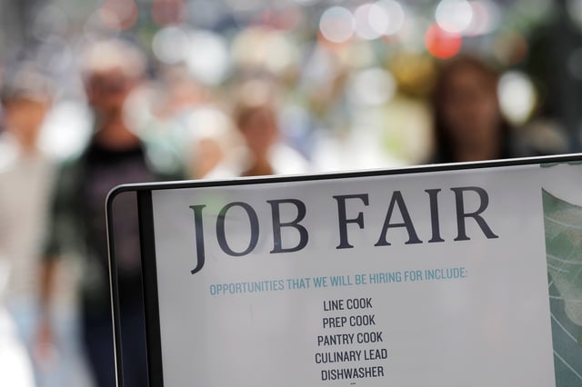 Signage for a job fair is seen on 5th Avenue after the release of the jobs report in Manhattan, New York City, U.S., September 3, 2021. REUTERS/Andrew Kelly