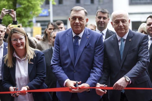 Bosnian Serb President Milorad Dodik, center, cuts the ribbon at the opening ceremony of the rectory building in Istocno Sarajevo, Bosnia, Thursday, April 24, 2025. (AP Photo/Armin Durgut)