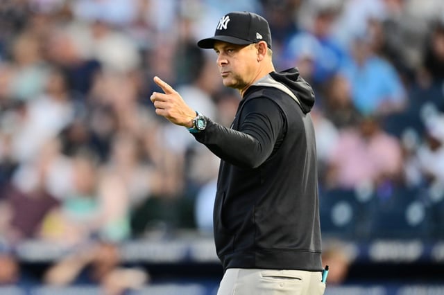 TAMPA, FLORIDA - APRIL 17: Manager Aaron Boone #17 of the New York Yankees points to the bullpen during a game against the Tampa Bay Rays at George M. Steinbrenner Field on April 17, 2025 in Tampa, Florida.
