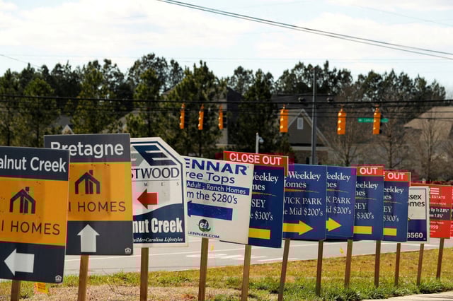 Real estate signs advertise new homes for sale in multiple new developments in York County, South Carolina, U.S., February 29, 2020. REUTERS/Lucas Jackson/File Photo