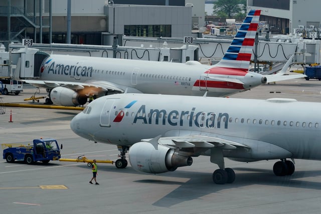 FILE - American Airlines passenger jets prepare for departure, Wednesday, July 21, 2021, near a terminal at Boston Logan International Airport, in Boston. (AP Photo/Steven Senne, File)