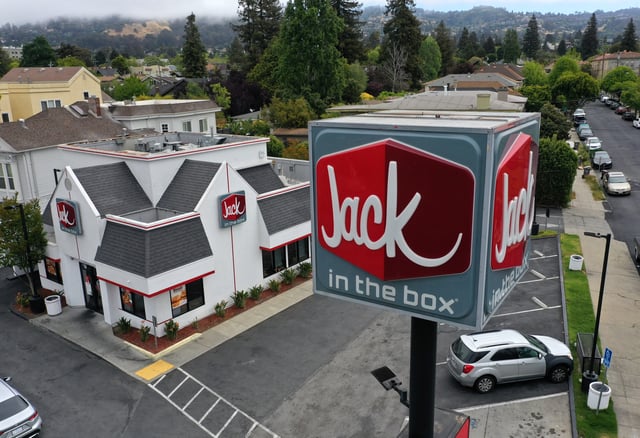 In an aerial view, a sign is posted in front of a Jack in the Box restaurant on May 12, 2021 in Berkeley, California.