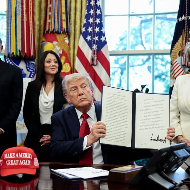 Trump shows off the signed AI education executive order.