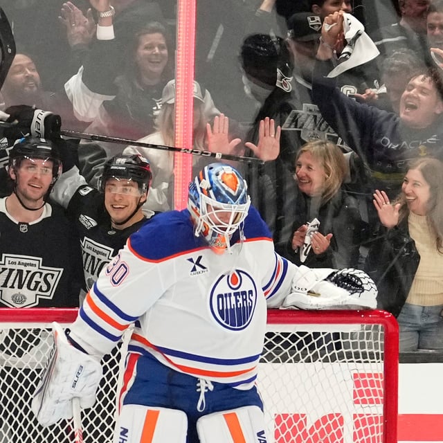 Los Angeles Kings right wing Adrian Kempe, second from left, celebrates his goal with defenceman Brandt Clarke, left, and left wing Andrei Kuzmenko, second from right, as Edmonton Oilers goaltender Calvin Pickard stands in goal during the third period in Game 2 of an NHL hockey first-round playoff series Wednesday, April 23, 2025, in Los Angeles. (AP Photo/Mark J. Terrill)