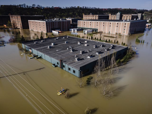 FILE - Kayakers paddle on the floodwaters at the Buffalo Trace Distillery on Monday, April 7, 2025, in Frankfort, Ky. (AP Photo/Jon Cherry, File)