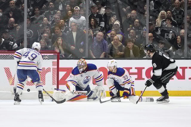 Los Angeles Kings right wing Adrian Kempe, right, scores on Edmonton Oilers goaltender Stuart Skinner, second from left, as defenceman Ty Emberson, left, and left wing Viktor Arvidsson watch during the third period in Game 2 of an NHL hockey first-round playoff series Wednesday, April 23, 2025, in Los Angeles. 