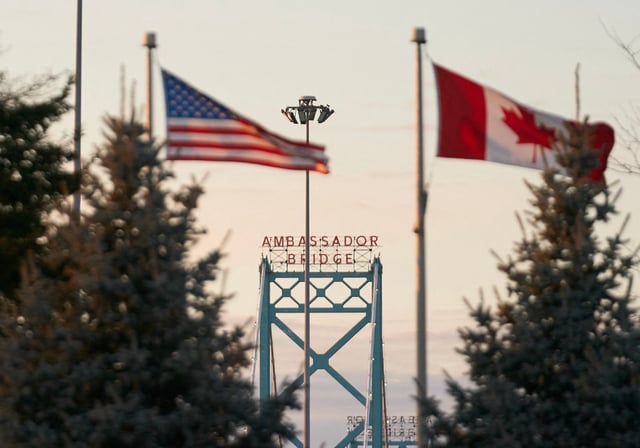 A file photo of Canadian and American flags fly on the Canadian side of the Ambassador Bridge in Windsor, Ont., on March 8, 2025.