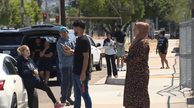 Parents waiting outside El Cajon Valley High School on Thursday after a shooting was reported nearby the campus.