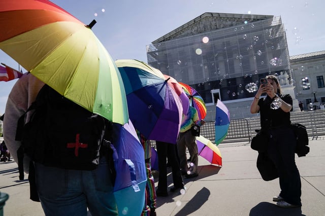 Supporters of LGBTQ rights hold rainbow-colored umbrellas as they demonstrate outside the U.S. Supreme Court, as the court hears oral arguments in the Mahmoud v. Taylor case, in Washington, D.C., on April 22, 2025.