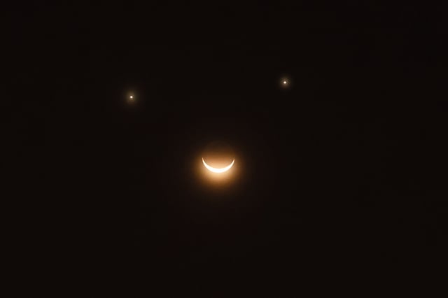 Saturn, Venus and the moon are lining up to make a cosmic smiley face, similar (but not exactly the same) to the one seen in this stock image. 