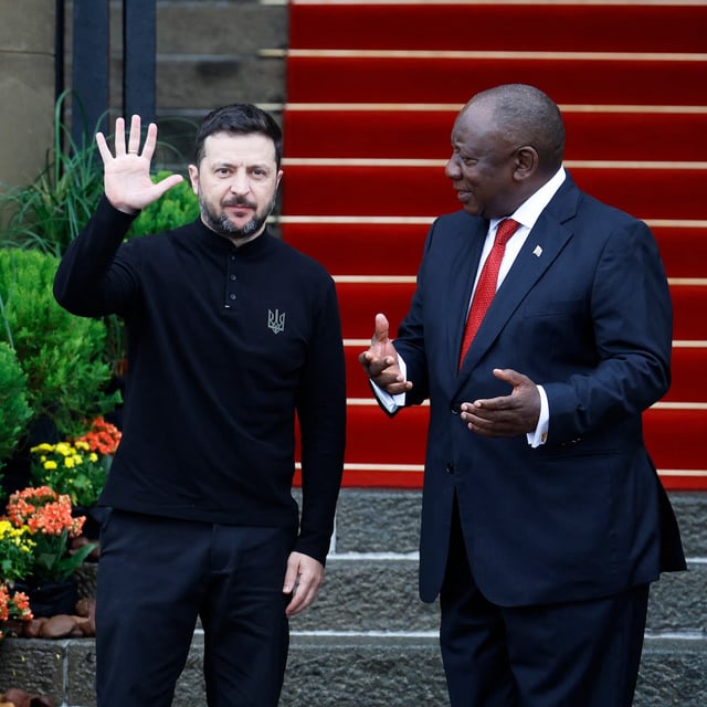 Ukraine's President Volodymyr Zelensky (L) waves as he is welcomed by South Africa's President Cyril Ramaphosa (R) during an official visit to South Africa, at the Union Buildings in Pretoria on April 24, 2024. (Photo by PHILL MAGAKOE / AFP) (Photo by PHILL MAGAKOE/AFP via Getty Images)