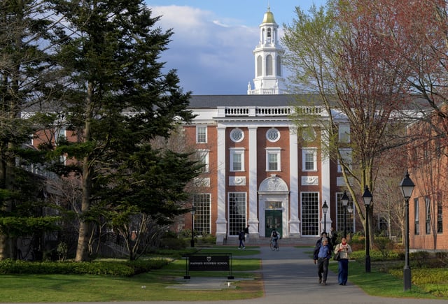 People walk on the Business School campus of Harvard University in Cambridge, Massachusetts, U.S., April 15, 2025. REUTERS/Faith Ninivaggi/File Photo