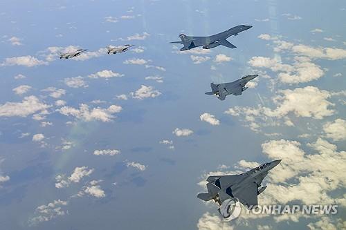 This image, provided by South Korea's defense ministry, show a B-1B bomber (R-B) during a joint South Korea-United States exercise. (PHOTO NOT FOR SALE) (Yonhap) 