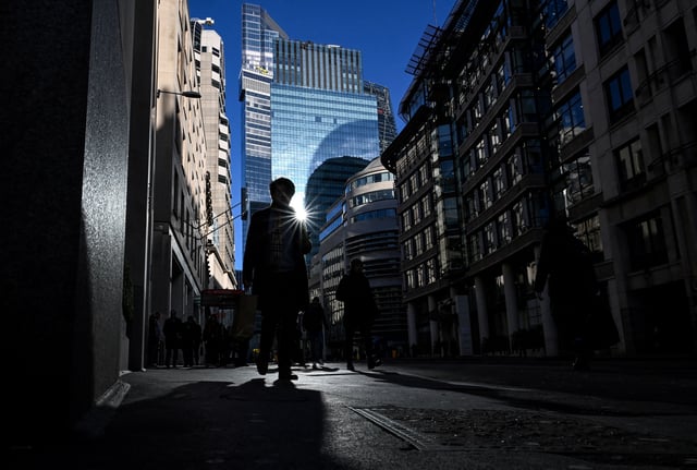 Workers make their way about the City of London on a cold and sunny day in London, Britain, January 9, 2025. REUTERS/Chris J. Ratcliffe