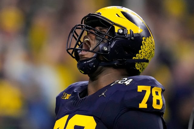 Michigan defensive lineman Kenneth Grant celebrates after sacking Washington quarterback Michael Penix Jr. during the first half of the national championship NCAA College Football Playoff game Monday, Jan. 8, 2024, in Houston. (AP Photo/Godofredo A. Vasquez)