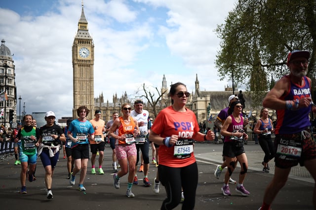Fun runners compete near the Houses of Parliament during the 2024 London Marathon in central London on April 21, 2024. (Photo by HENRY NICHOLLS / AFP) / &#34;Restricted to editorial use - sponsorship of content subject to LMEL agreement&#34;. (Photo by HENRY NICHOLLS/AFP via Getty Images)