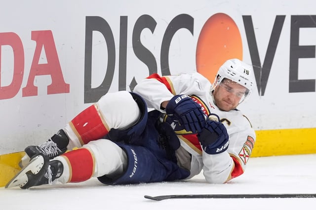 Florida Panthers center Aleksander Barkov tries to get up after getting knocked down by Tampa Bay Lightning left wing Brandon Hagel during the third period in Game 2 of an NHL hockey Stanley Cup first-round playoff series, Thursday, April 24, 2025, in Tampa, Fla. (AP Photo/Chris O&#39;Meara)