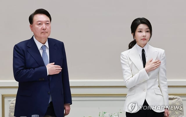 South Korean President Yoon Suk Yeol (L), alongside his wife, Kim Keon Hee, salutes the national flag during a luncheon with the South Korean squad for the Paris Paralympics at the guesthouse of Cheong Wa Dae in Seoul, in this file photo dated Sept. 13, 2024. The Constitutional Court upheld the impeachment of Yoon on April 4, 2025, removing him from office over his short-lived imposition of martial law in December. (Yonhap)