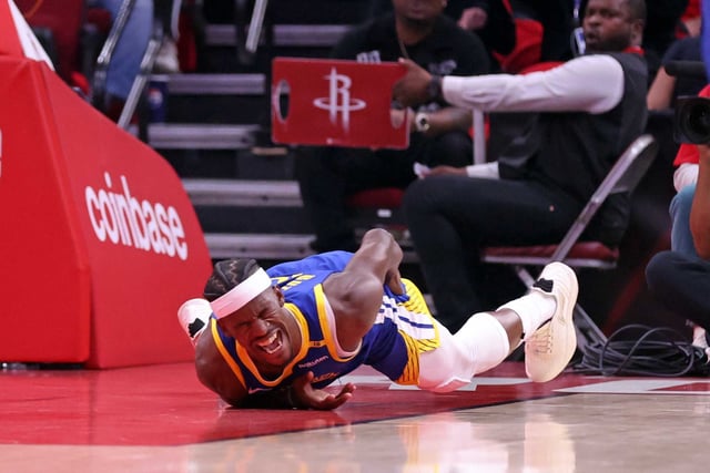 Golden State Warriors’ Jimmy Butler writhes in pain after injuring himself in 1st quarter against Houston Rockets in Game 2 of First Round of NBA Playoffs at Toyota Center in Houston, Texas on Wednesday, April 23, 2025.