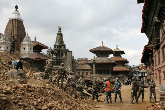 Nepalese police and army personnel on April 29, 2015, clear the rubble of temples at Durbar square, damaged by the earthquake in Kathmandu