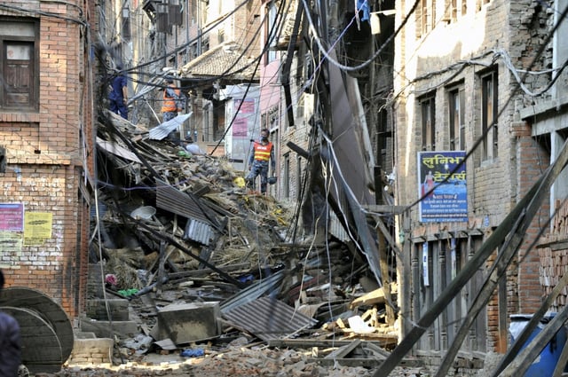 Rescuers look at damaged buildings  in Bhaktapur, on the outskirts of Kathmandu, on April 27, 2015