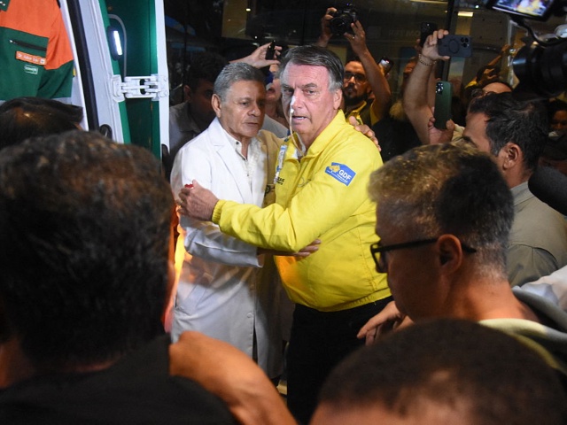 Former Brazilian President Jair Bolsonaro is pictured before boarding an ambulance as he leaves Rio Grande Hospital in Natal, Rio Grande do Norte state, Brazil, on April 12, 2025. Brazil's ex-president Jair Bolsonaro said Saturday that he will "probably" need surgery, after being hospitalized a day earlier in the northeastern city of Natal with what he called "unbearable" abdominal pain. The far-right former leader said on X that he would "probably be operated on again" after being transferred to a hospital in Brasilia. (Photo by Jose ALDENIR / AFP)