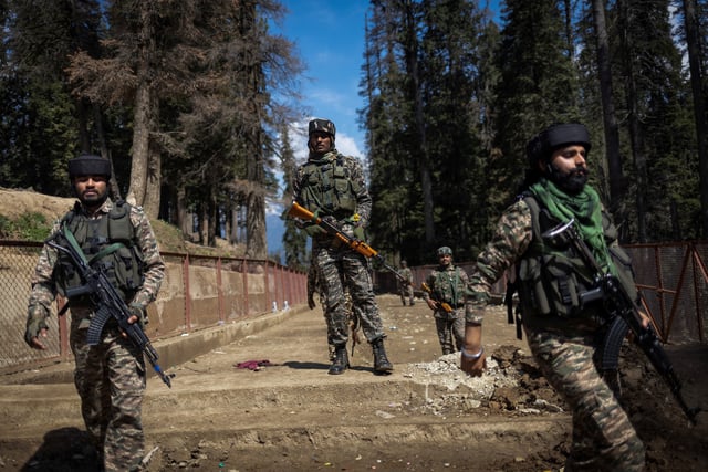 Indian security force personnel stand guard at the site of a suspected militant attack on tourists in Baisaran near Pahalgam in south Kashmir's Anantnag district, April 24, 2025. REUTERS/Adnan Abidi