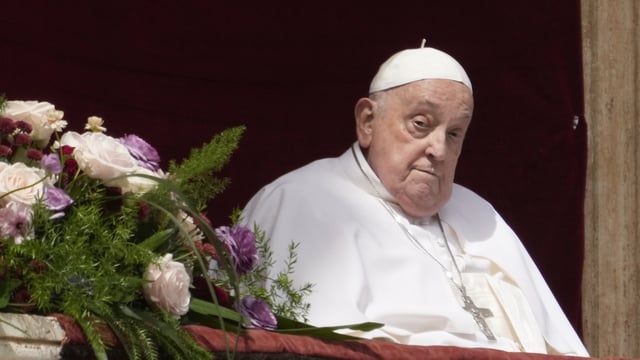 Pope Francis appears on the central lodge of St. Peter's Basilica to bestow the Urbi et Orbi blessing at the end of the Easter Mass in St. Peter's Square at the Vatican, April 20, 2025.
