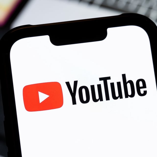 YouTube logo shown on a smartphone.