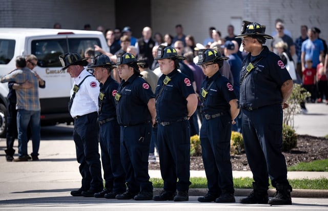 Firefighters stand at attention for Chicago Fire Department Capt. David Meyer, 54, who died on duty Wednesday, after a procession arrives at Malec &amp; Sons Funeral Home in the Norwood Park neighborhood from the Cook County medical examiner’s office on April 24, 2025. (E. Jason Wambsgans/Chicago Tribune)