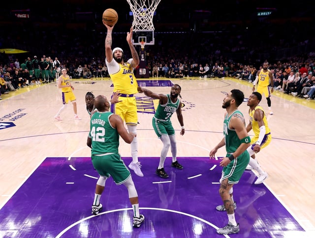 Anthony Davis #3 of the Los Angeles Lakers shoots between Al Horford #42, Jayson Tatum #0, Jaylen Brown #7 and Jrue Holiday #4 of the Boston Celtics during a 117-96 Lakers win at Crypto.com Arena on January 23, 2025 in Los Angeles, California.
