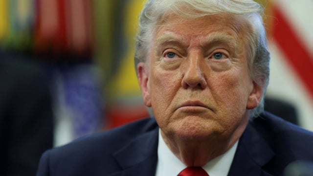 U.S. President Donald Trump looks on, as he signs executive orders in the Oval Office at the White House in Washington, D.C., U.S., April 23, 2025.