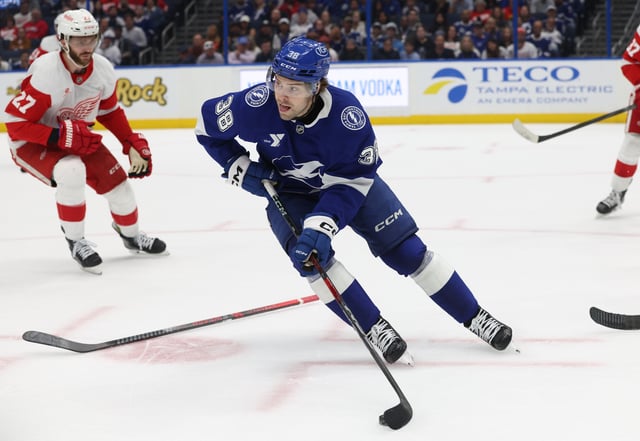 Apr 11, 2025; Tampa, Florida, USA; Tampa Bay Lightning left wing Brandon Hagel (38) skates with the puck as Detroit Red Wings center Michael Rasmussen (27) defends during the first period at Amalie Arena. Mandatory Credit: Kim Klement Neitzel-Imagn Images/ File Photo