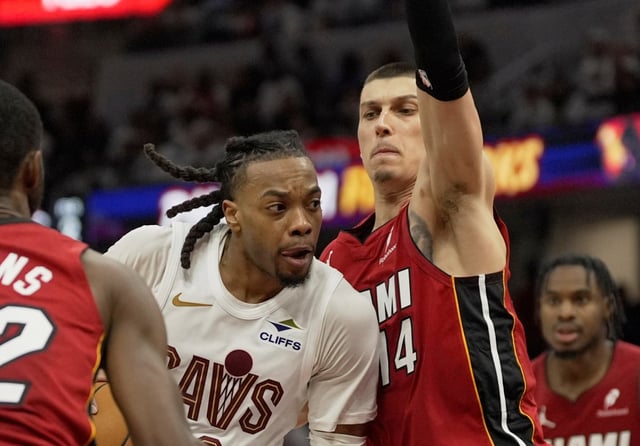 Cleveland Cavaliers guard Darius Garland against Miami Heat guard Tyler Herro  in the second half in Game 1 of an NBA first-round playoff series, Sunday, April 20, 2025, in Cleveland. (AP Photo/Sue Ogrocki)