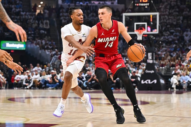 Darius Garland #10 of the Cleveland Cavaliers guards Tyler Herro #14 of the Miami Heat during the second quarter of game one of the first round of the Eastern Conference Playoffs at Rocket Arena on April 20, 2025 in Cleveland, Ohio.