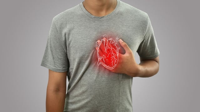 Digital composition of human heart with highlighted red inflammation on sick person, man with chest pain, health and medical concept