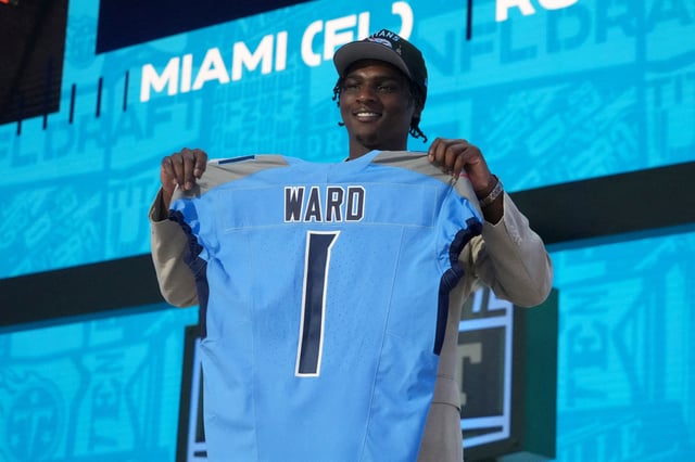 Apr 24, 2025; Green Bay, WI, USA; Miami Hurricanes quarterback Cameron Ward holds the jersey on stage after he is selected by the Tennessee Titans as the number one pick in the first round of the 2025 NFL Draft at Lambeau Field. Mandatory Credit: Kirby Lee-Imagn Images/File Photo