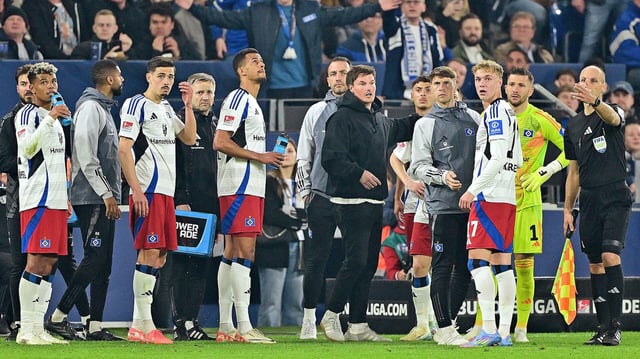 Spieler und Trainer des HSV stehen zusammen.