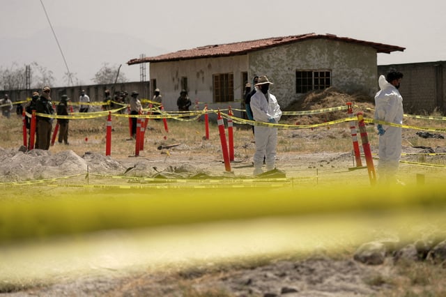 FILE PHOTO: Forensic technicians stand at a cordoned area during a media tour by Jalisco's Attorney General Office at Izaguirre Ranch, which activists have called a cartel-run "extermination camp," in Teuchitlan, Jalisco state, Mexico March 20, 2025. REUTERS/Ivan Arias/File Photo