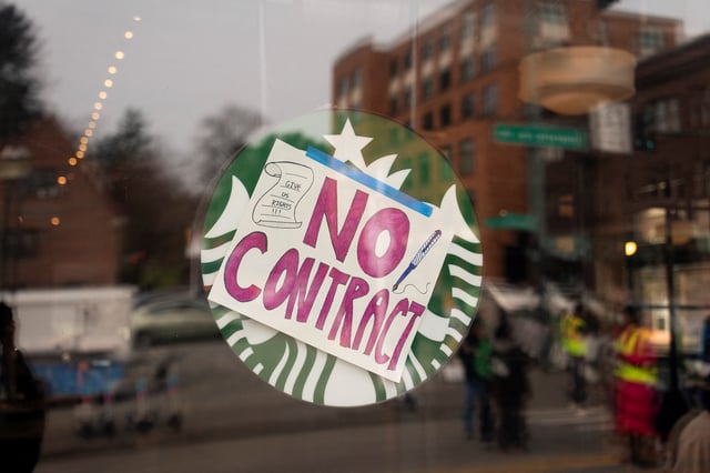 A pro-union sign covers a corporate logo in the window of a Starbucks location during a strike and rally organized by Starbucks Workers United in Seattle, Washington, U.S., March 11, 2025. REUTERS/David Ryder